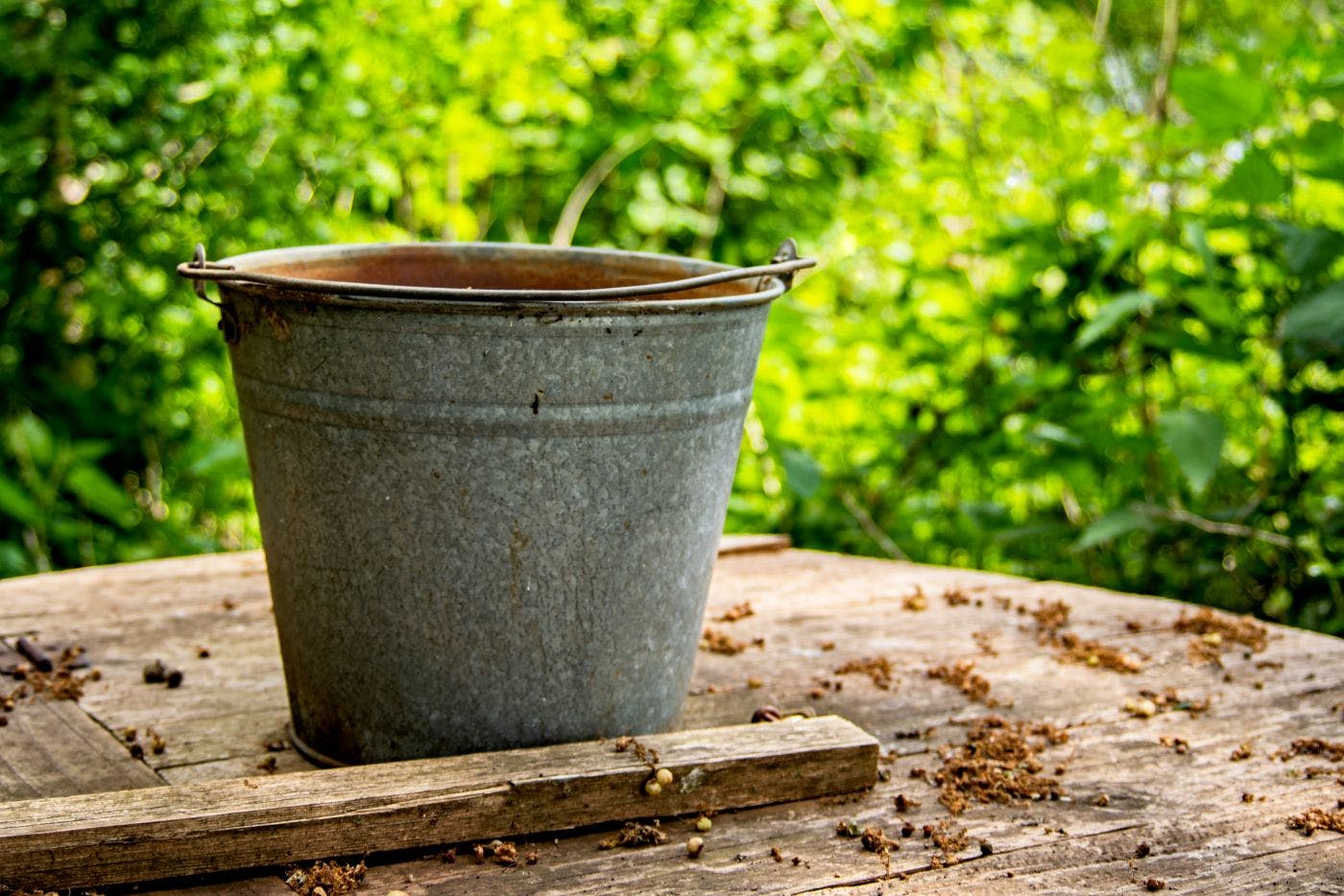 A steel bucket on an outdoor table