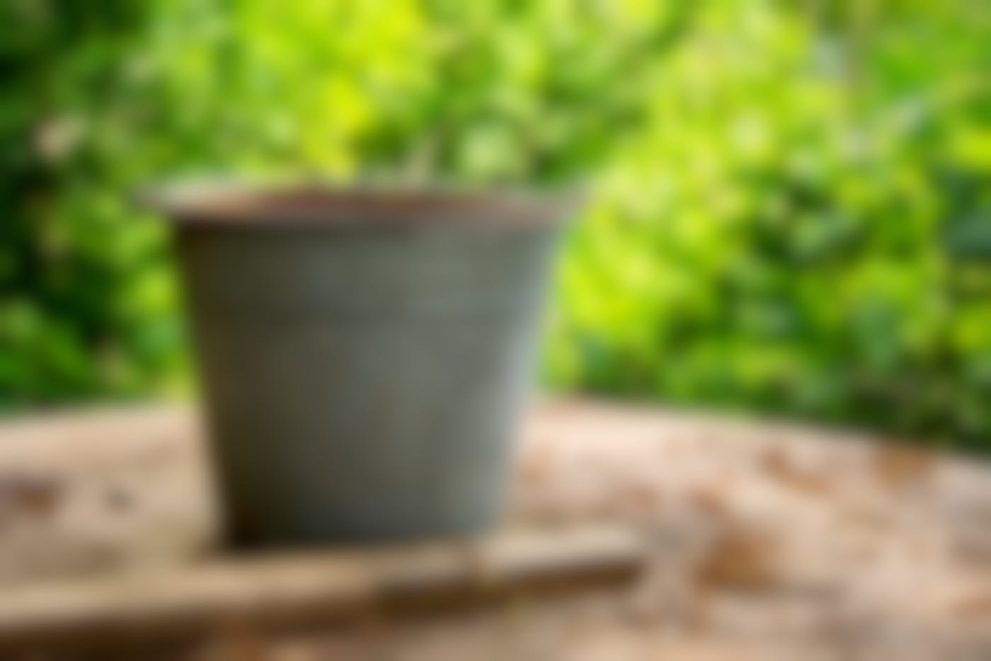 A steel bucket on an outdoor table