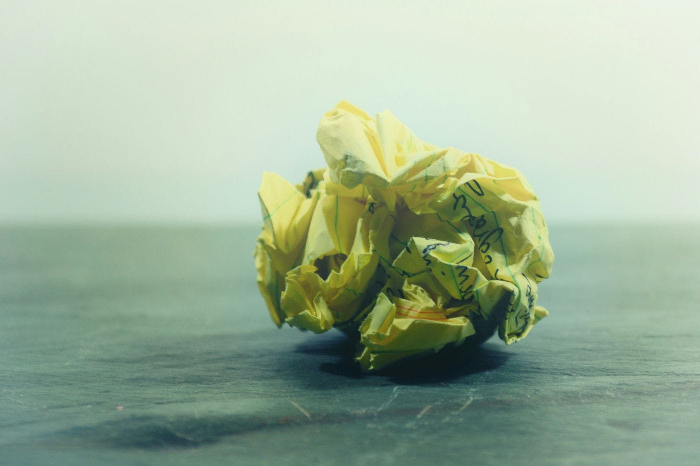 A crumpled sheet of yellow legal paper