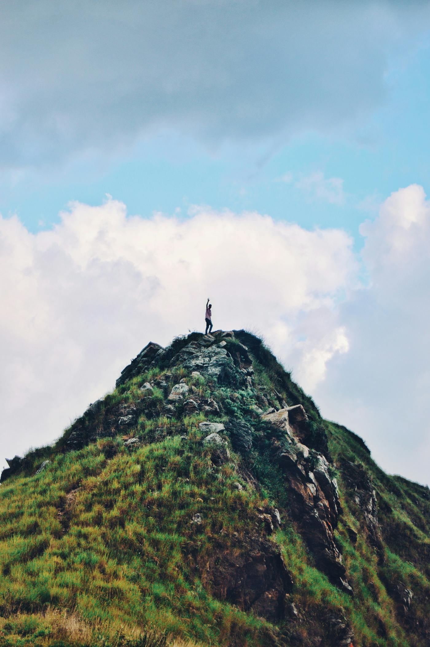 A person standing at the top of a mountain