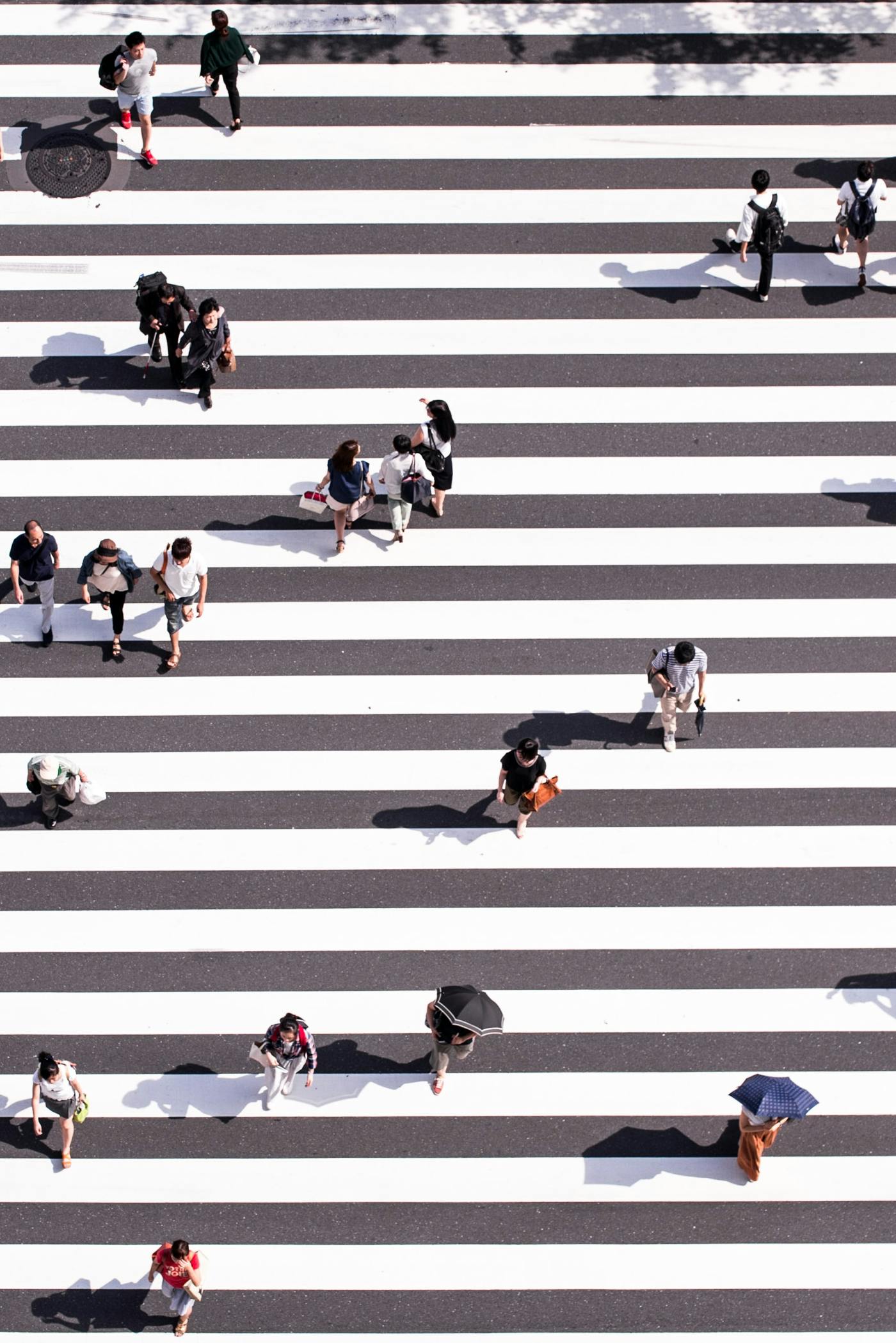 ariel view of people on a black and white crosswalk