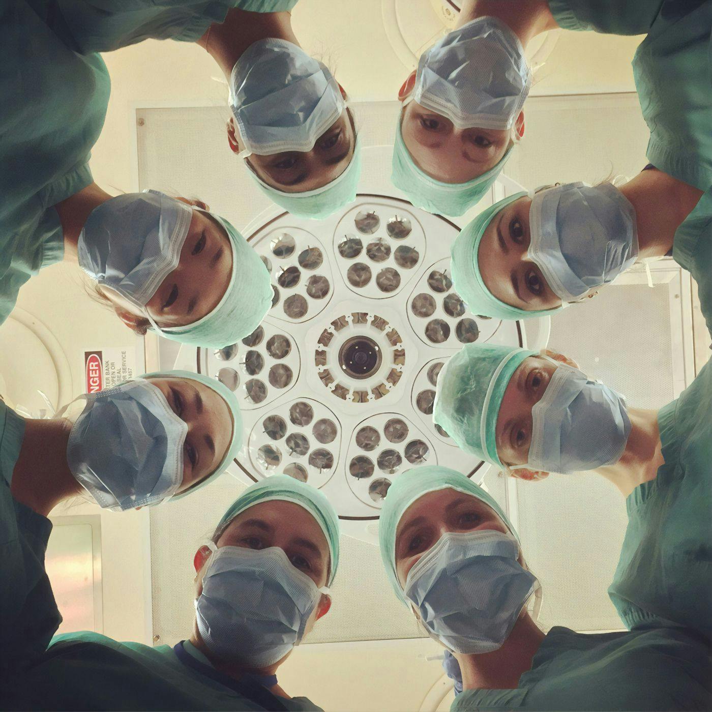 An upward view of doctors and nurses looking at an operation table