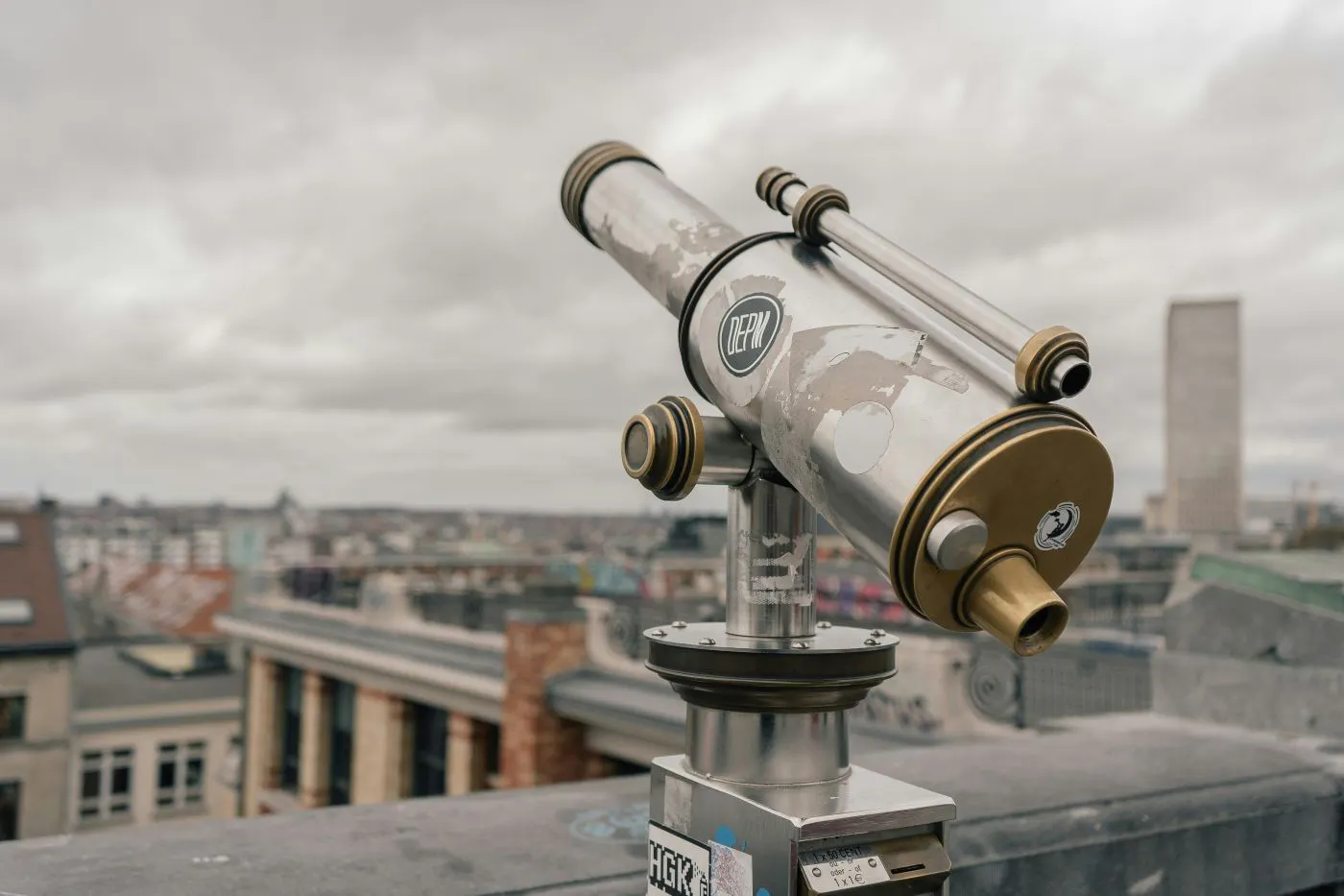 A coin operated telescope on the top of a tall building
