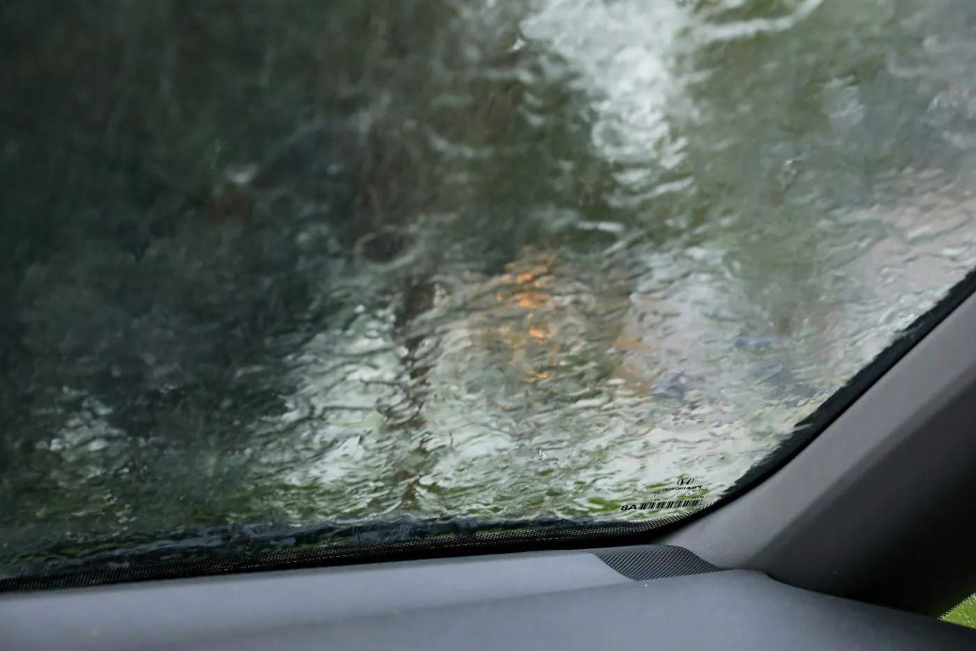Interior car windshield covered with rain