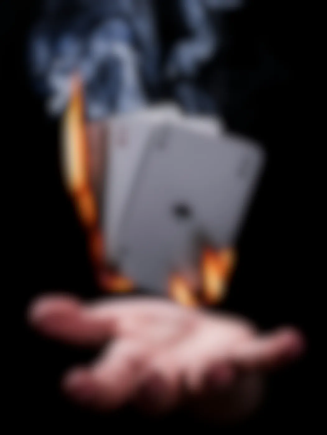 the four aces, on fire, hovering above a hand