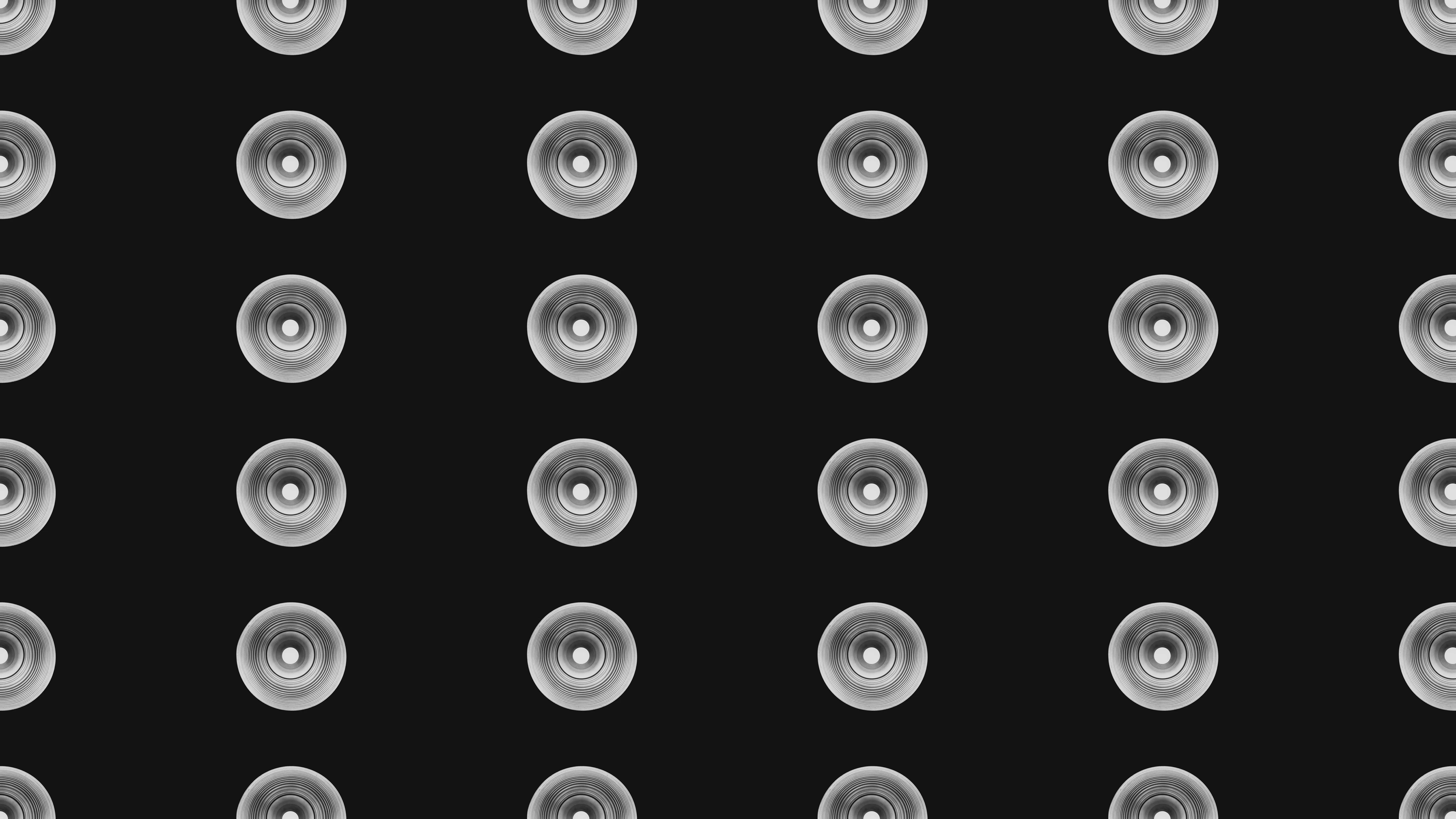 A grid of speakers against a black backdrop