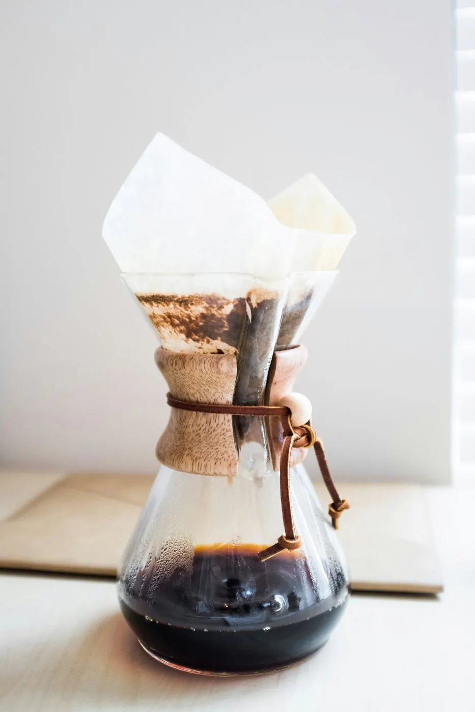 A glass carafe with a coffee filter in it