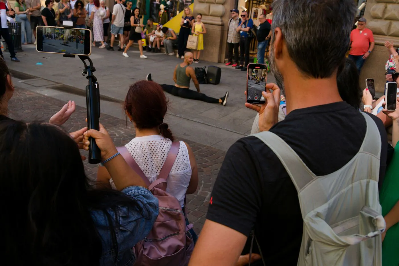 A street performer in front of a crowd filiming
