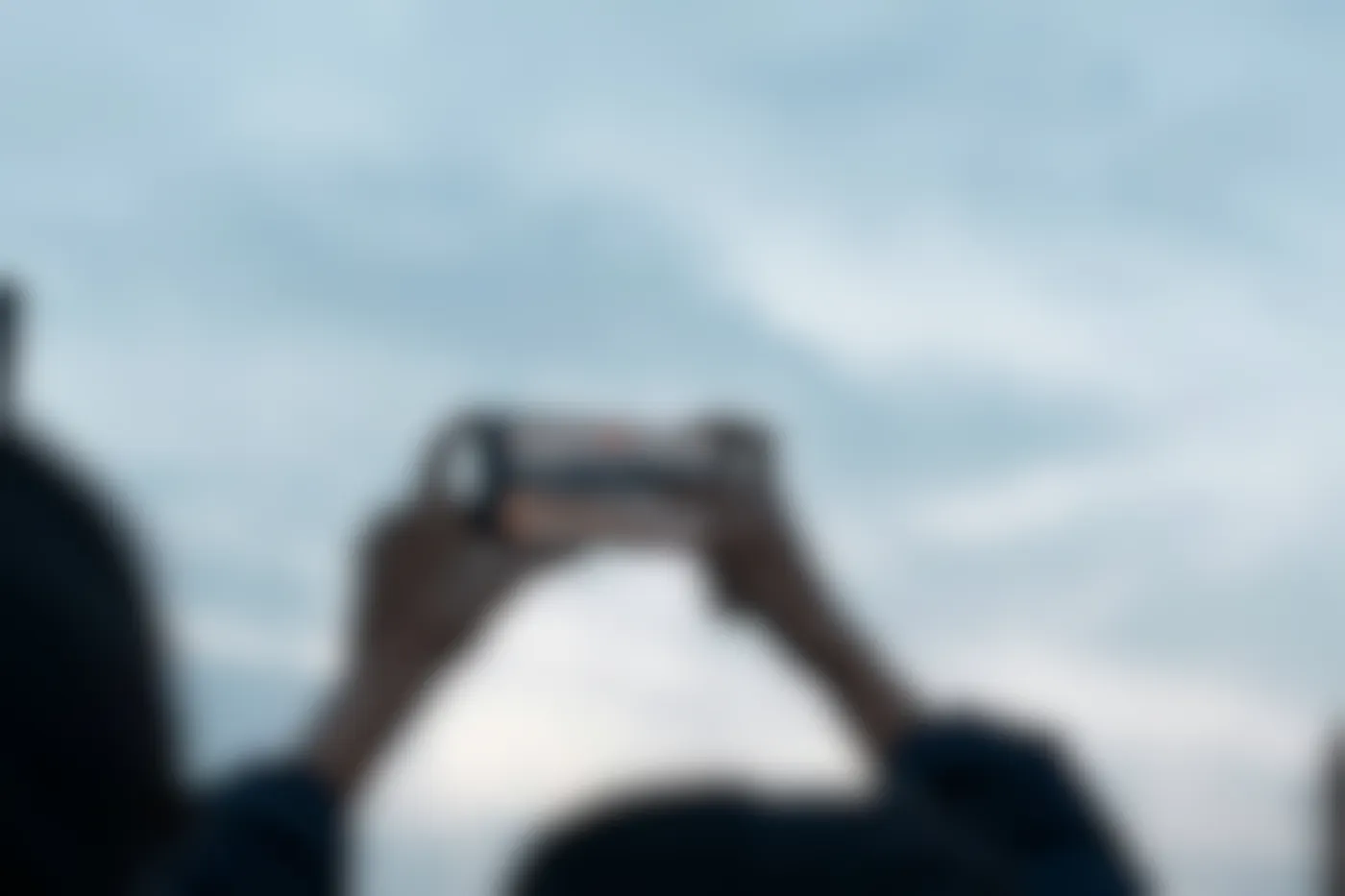 A person holding their phone over their head and filming