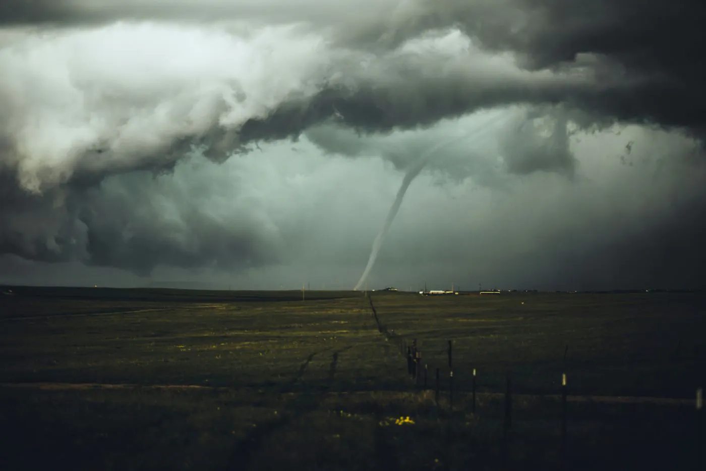 A tornado touching down across a field