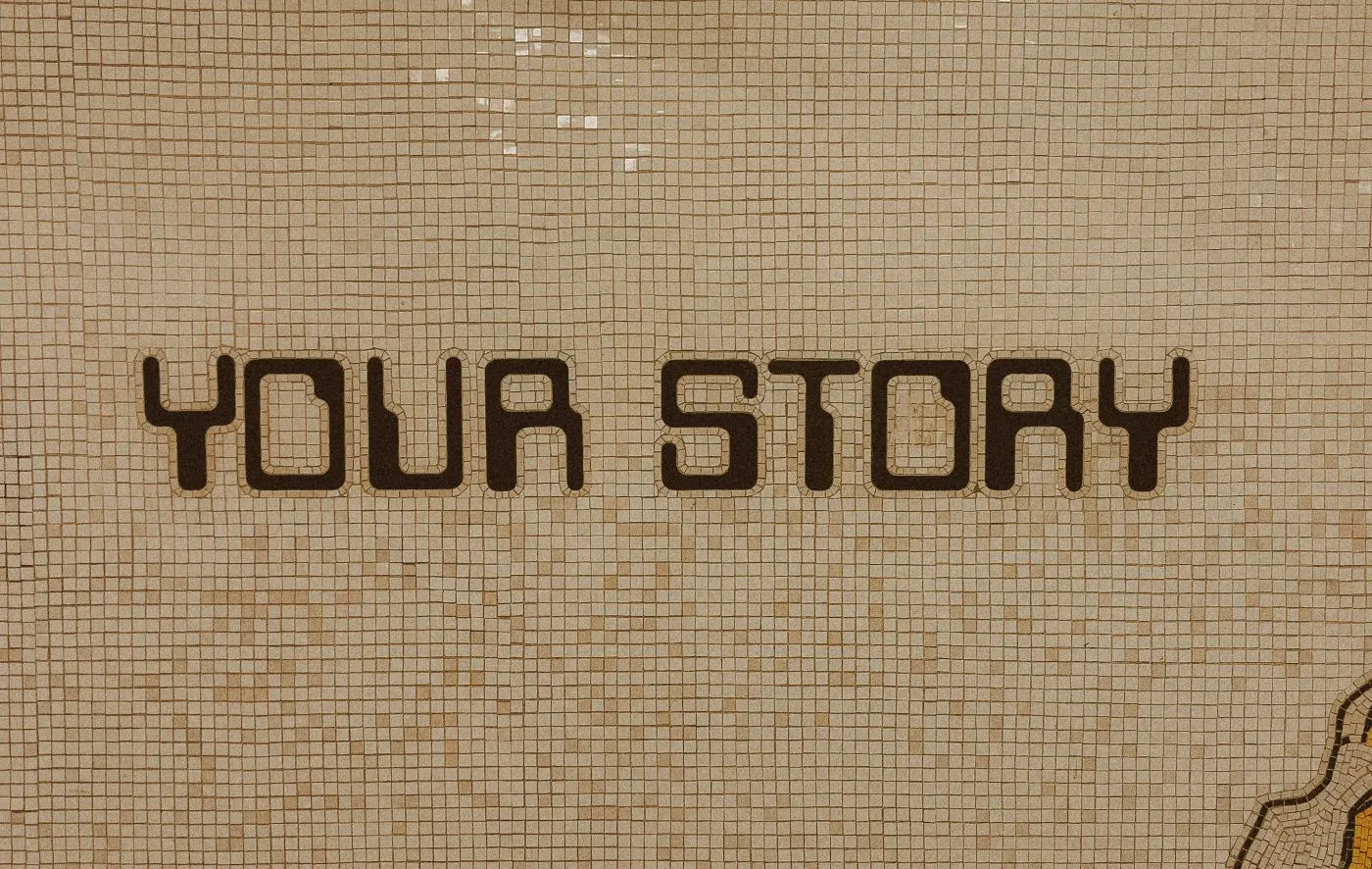 A tan tiled wall with Your Story spelled out in darker tiles