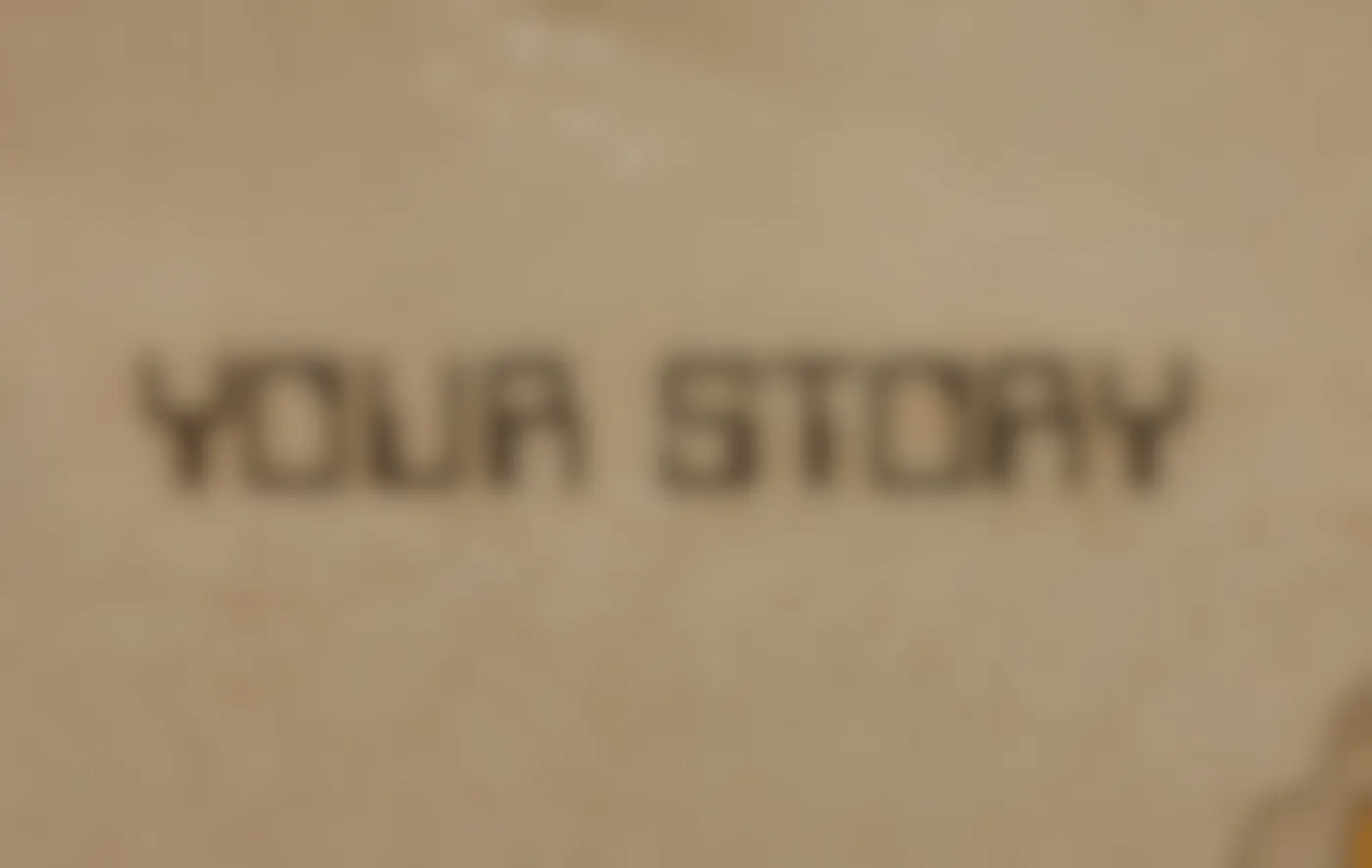 A tan tiled wall with Your Story spelled out in darker tiles