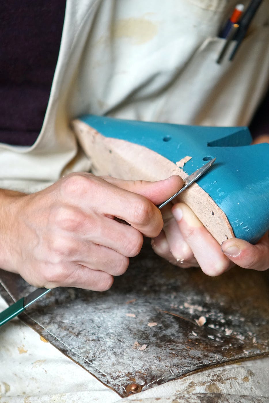 a person carving footwear