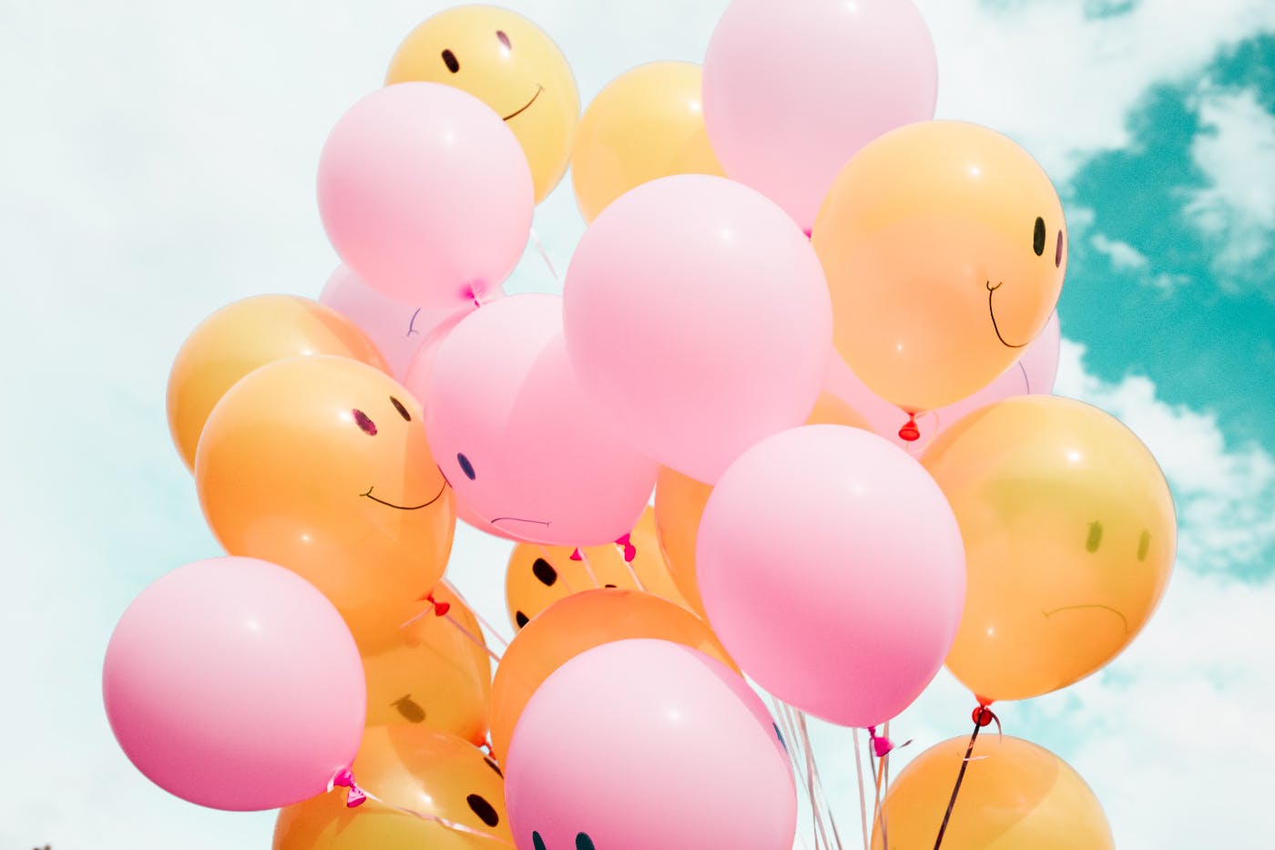 Yellow balloons with smiley faces, pink balloons with frowns