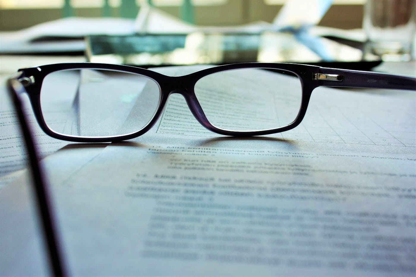 Black frame glasses sitting on a contract