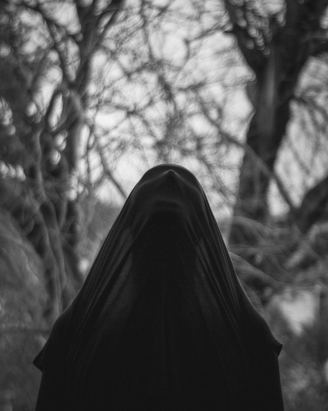 A person in a black cloak