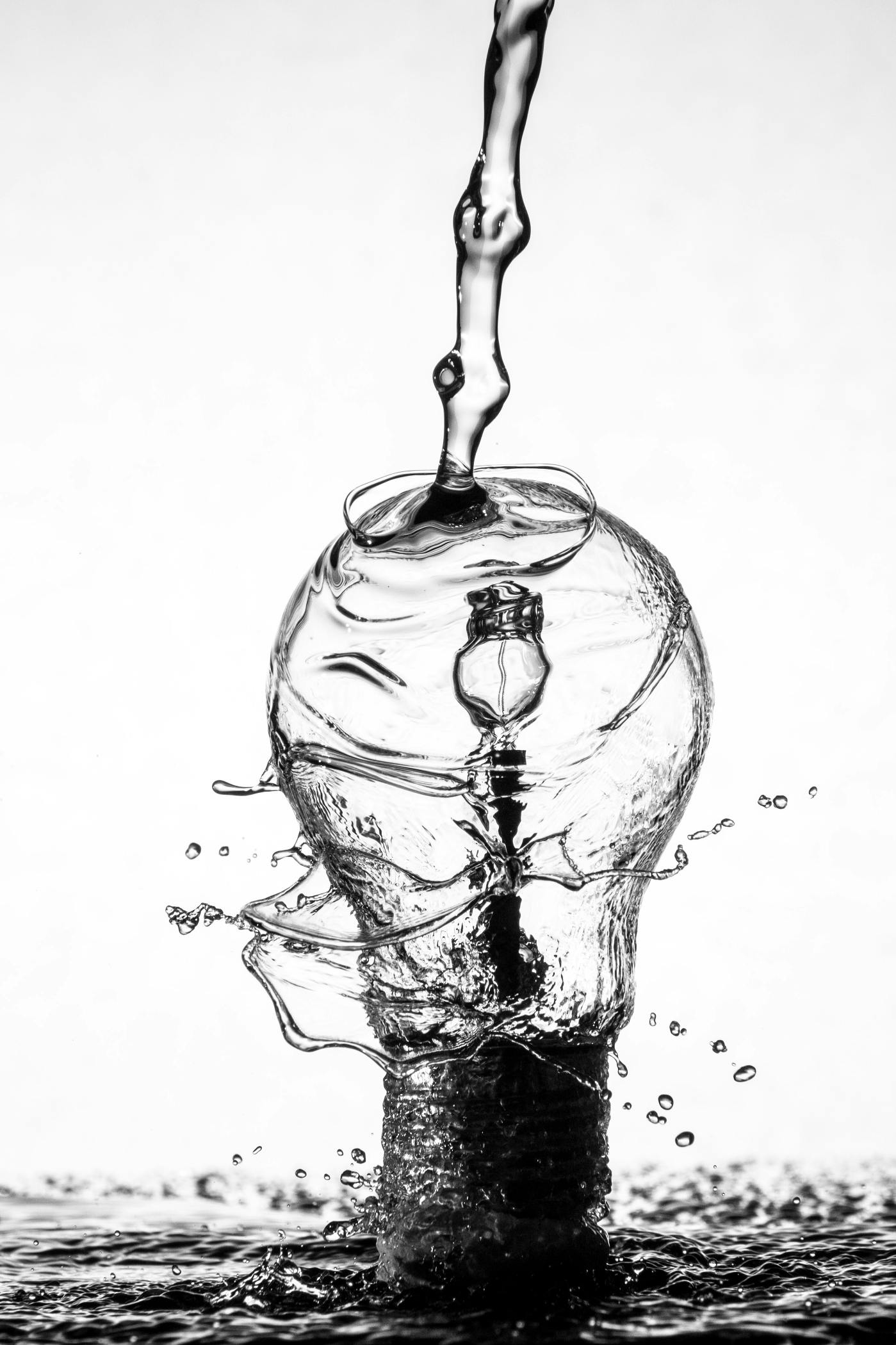 A lightbulb being doused with water.