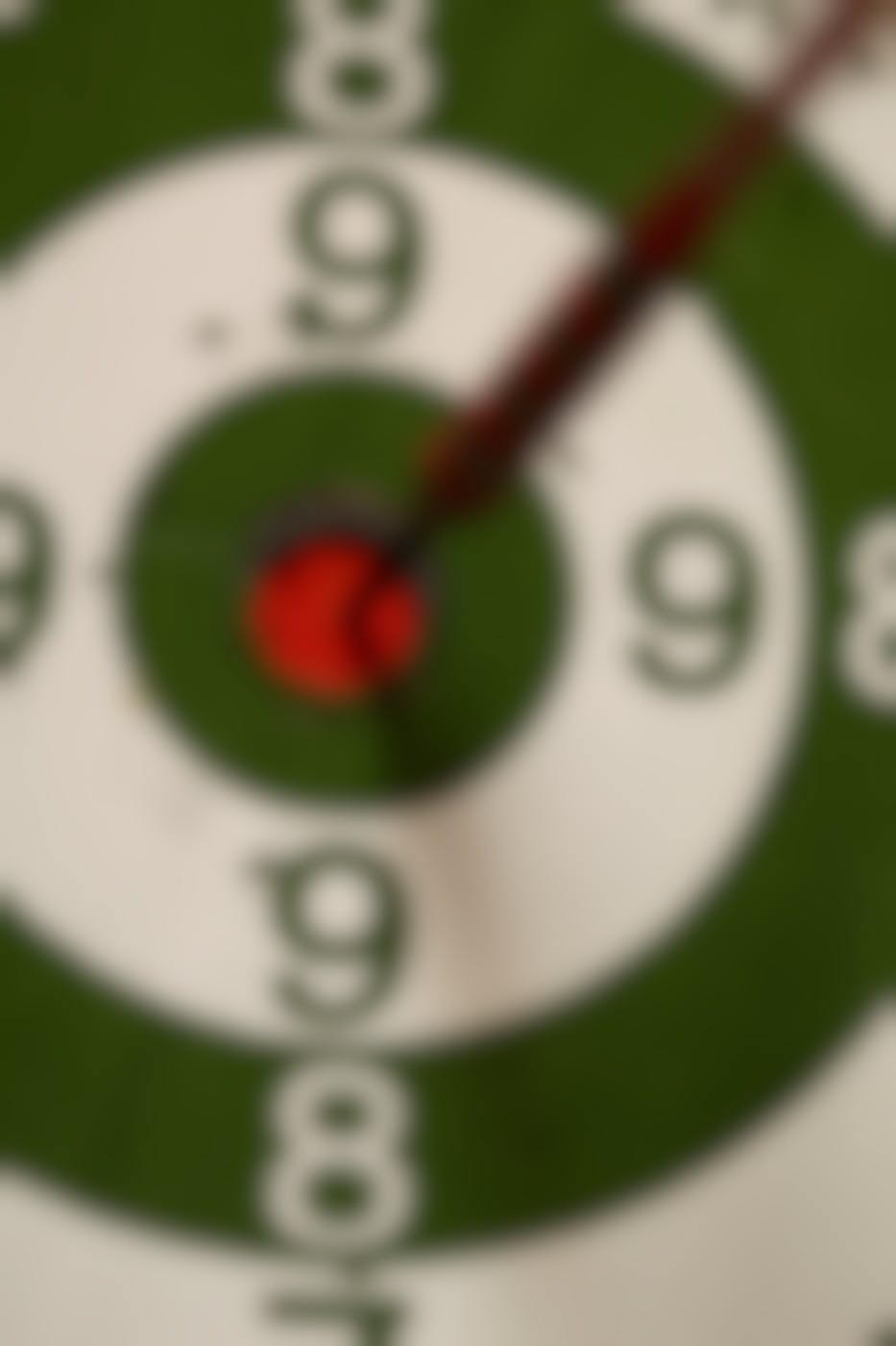 Close up on a dart board with a dart in the bullseye