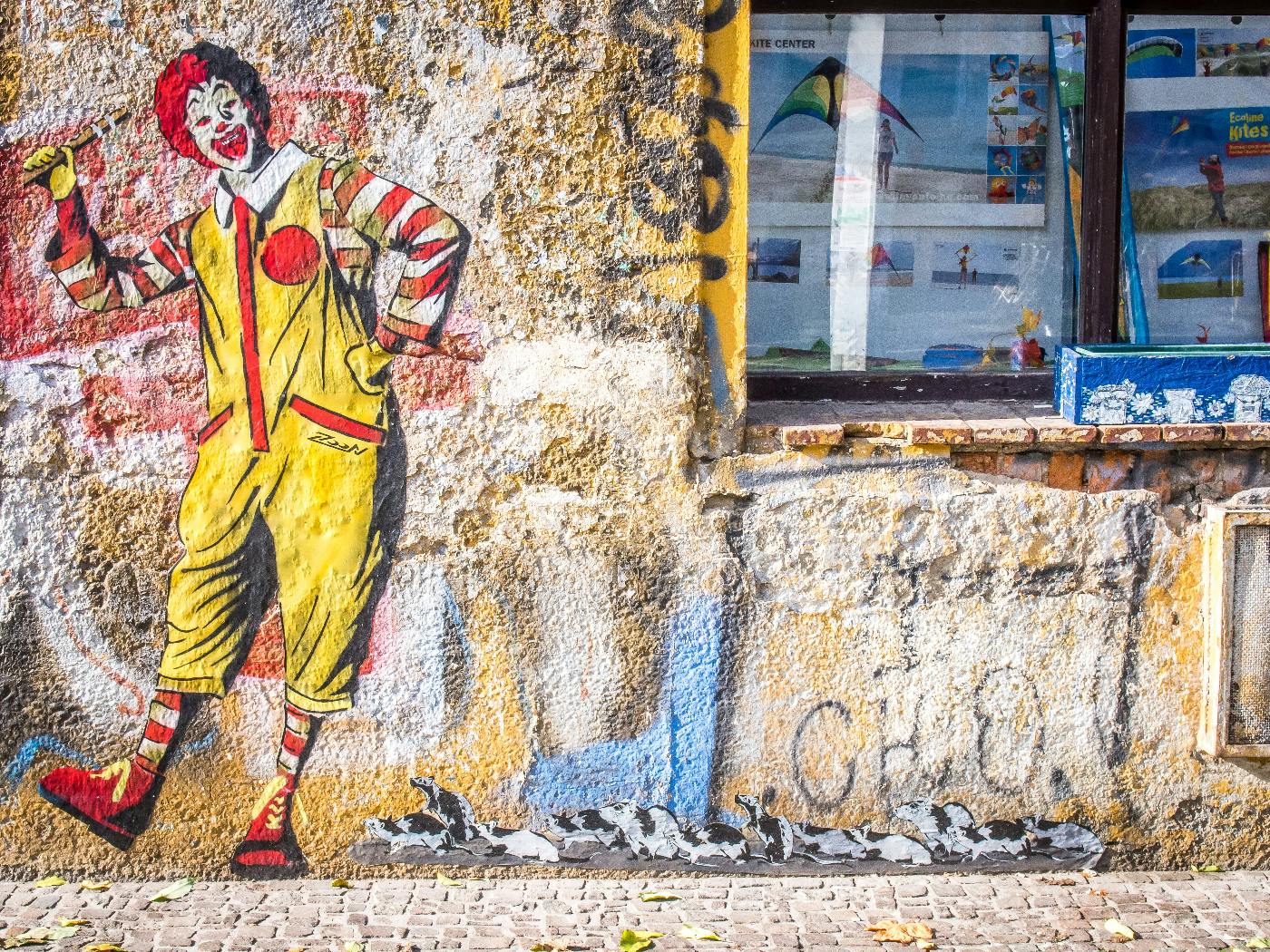 A Banksy-esque drawing of Ronald McDonald on the outer wall of a shop