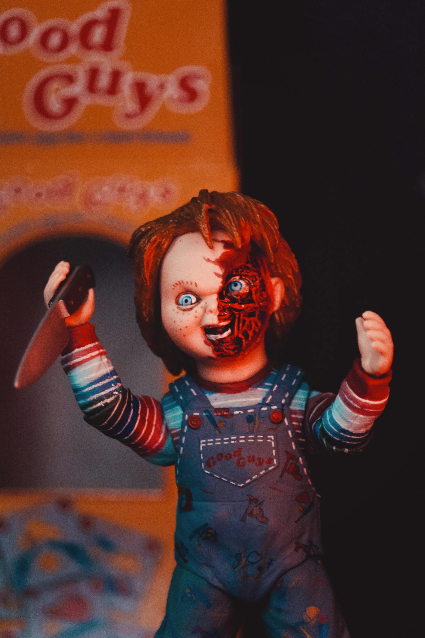 a mauled and bloody doll carrying a knife