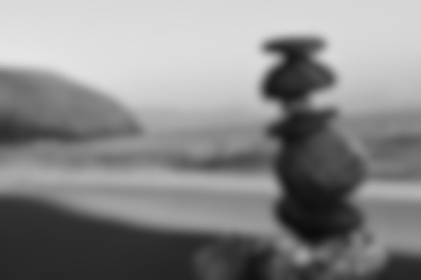 a small tower of rocks balanced on each other on a beach