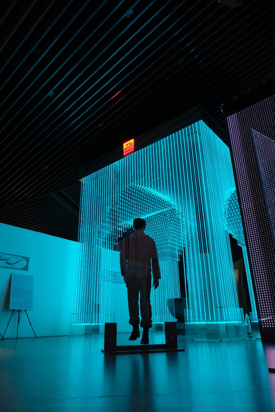 A futuristic light display with the image of a person floating in it