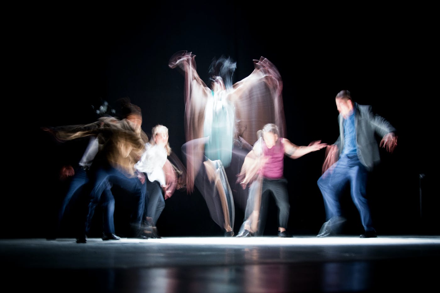 A group of people on stage in motion