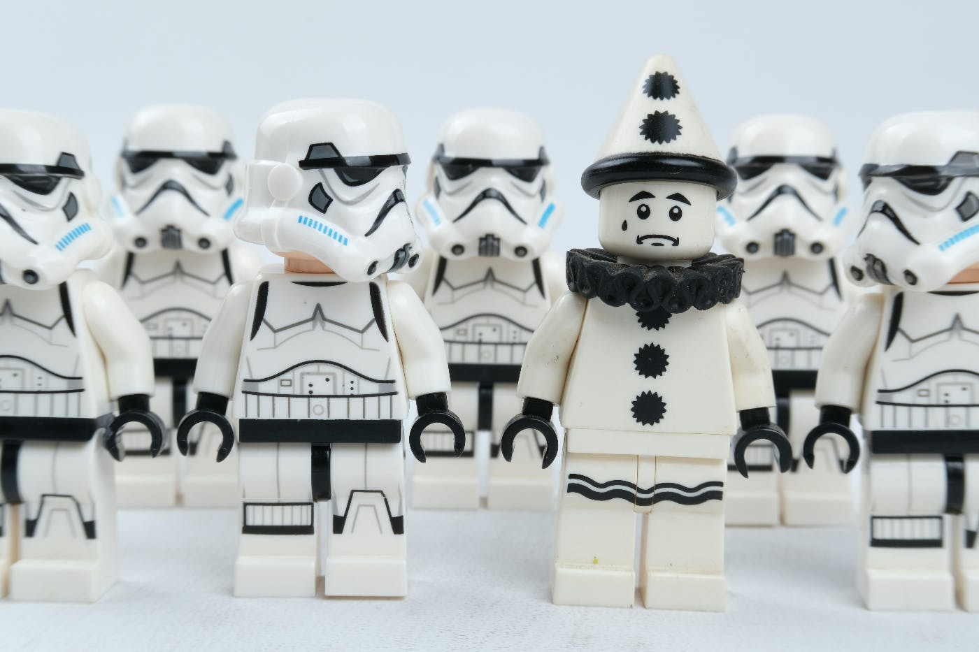 A group of Lego storm troupers from Star Wars with one trouper in the front looking at a black and white Rigoletto Lego