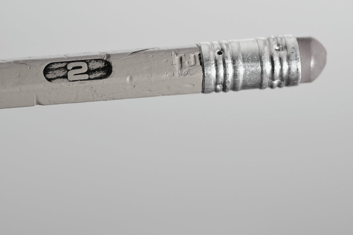 A black and white image of the eraser end on a number 2 pencil.