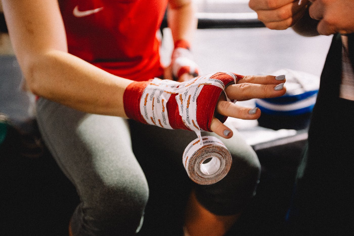 A boxer having his hands taped before a fight