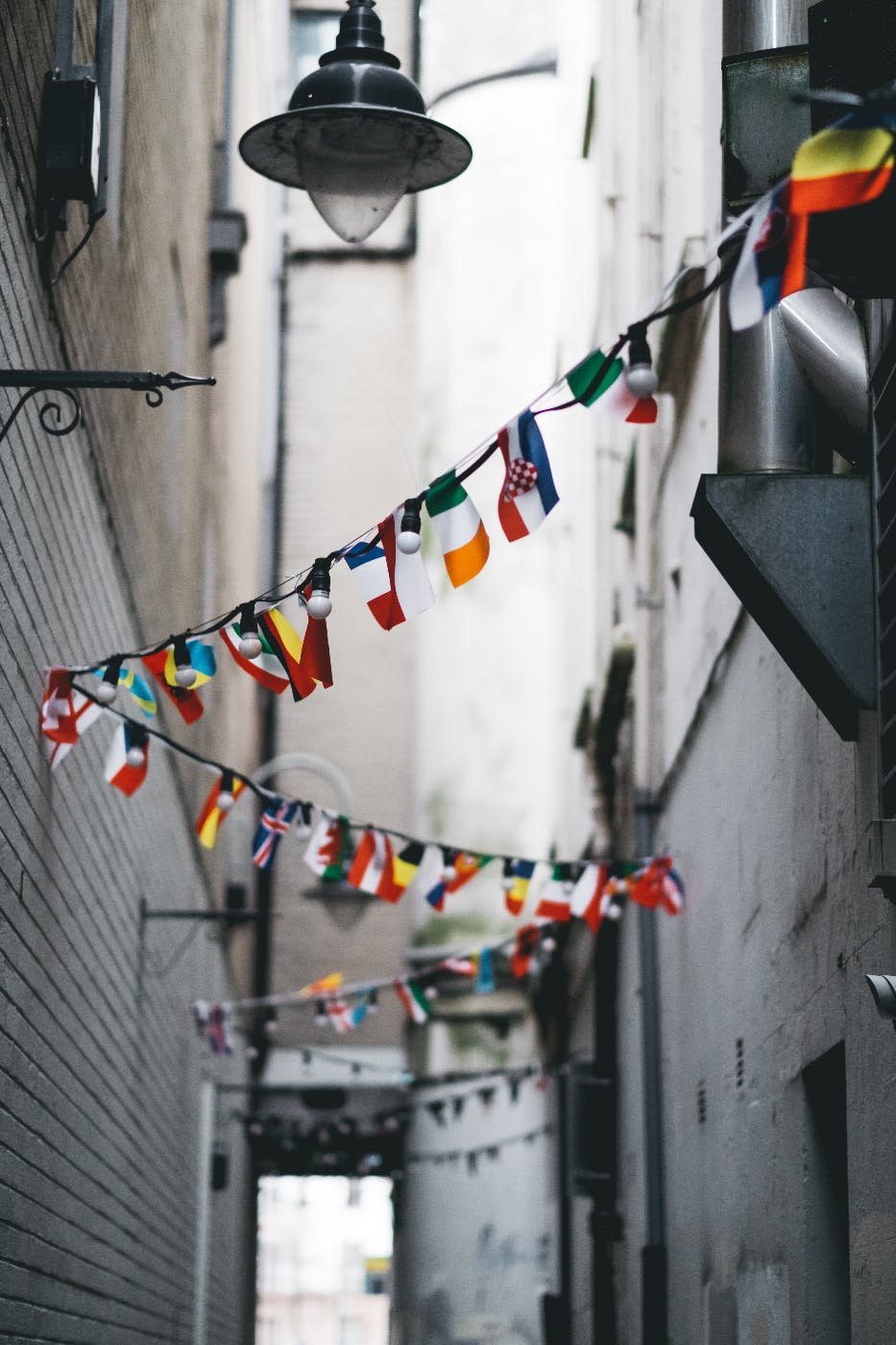 Flags from different nations strung up in an alley