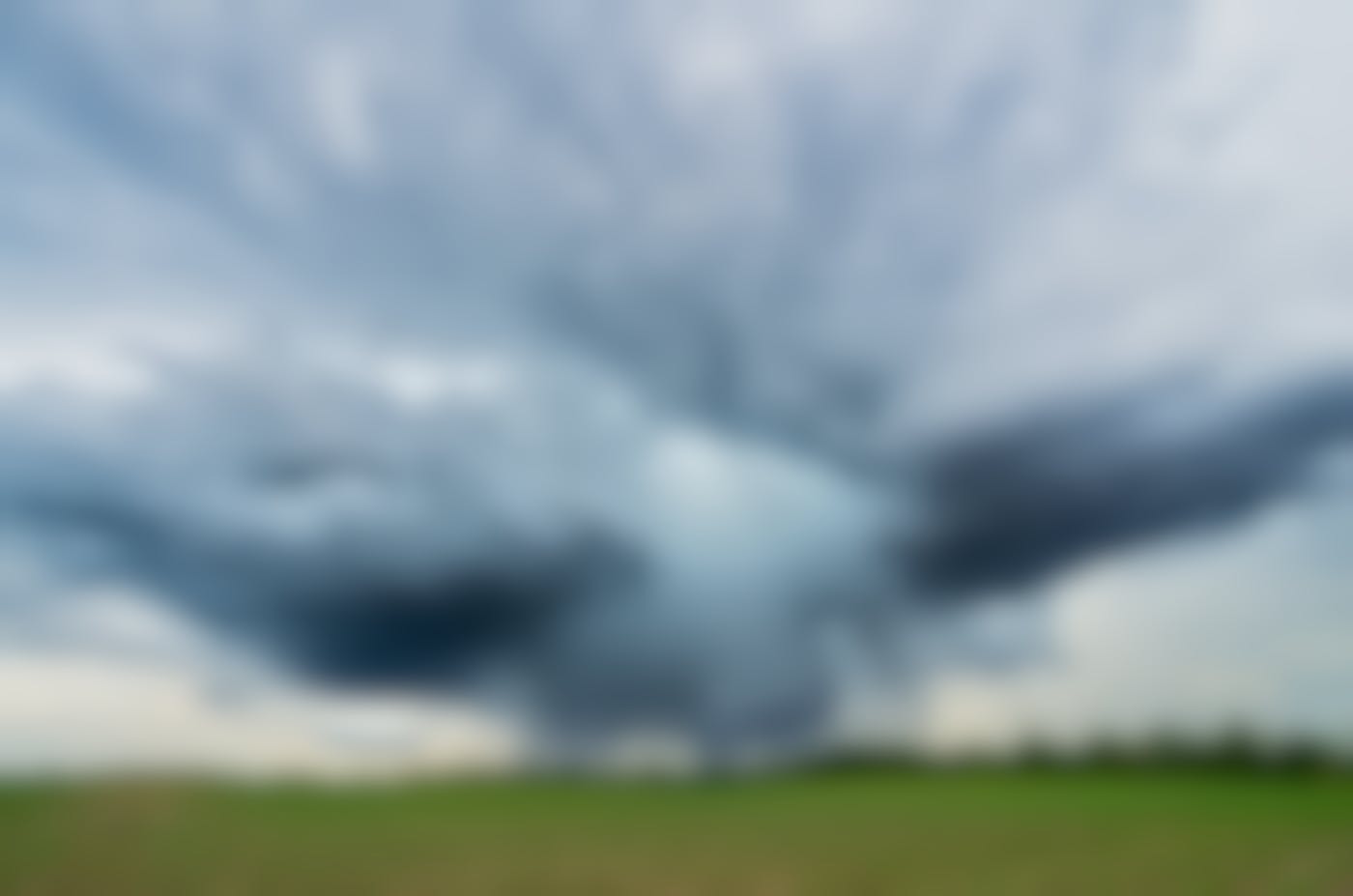 Storm clouds over a green field