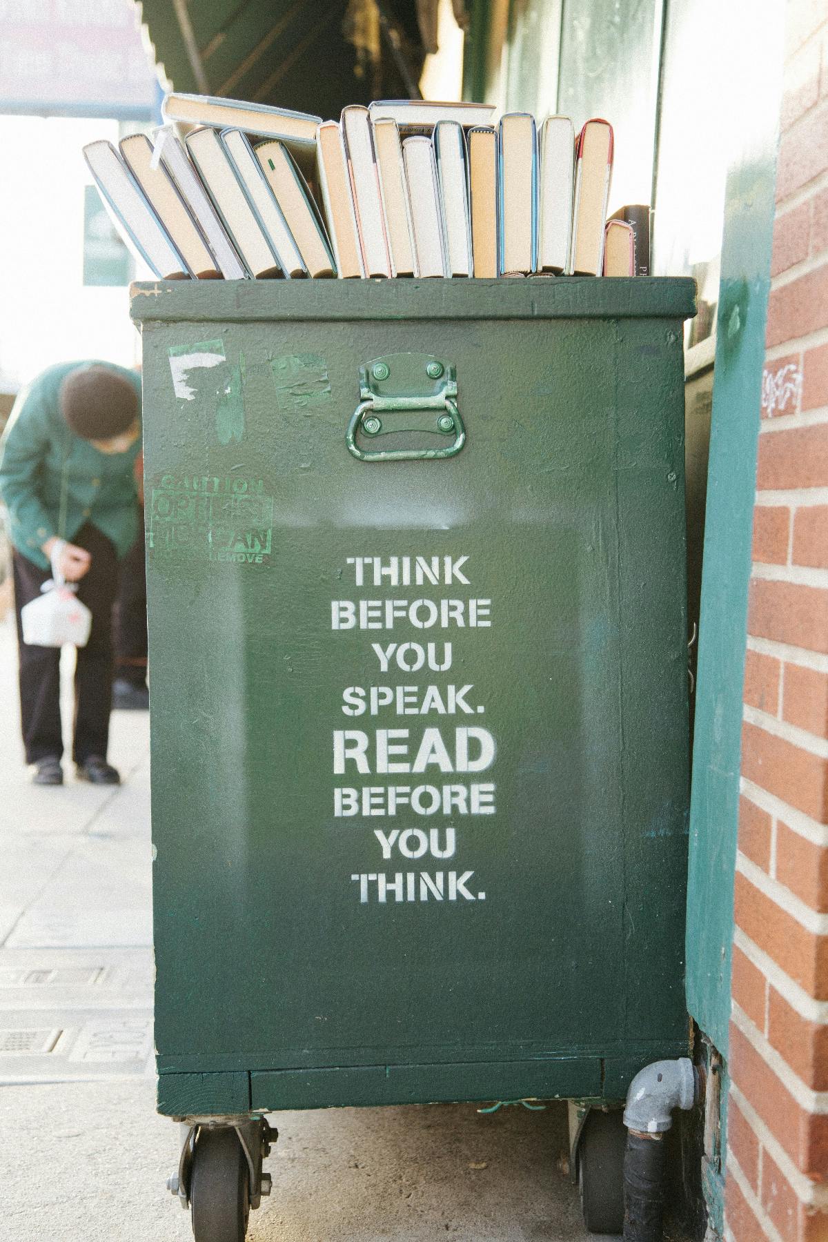 Side view of a book shelf on wheels with the words: Think before you speak. READ before you think.