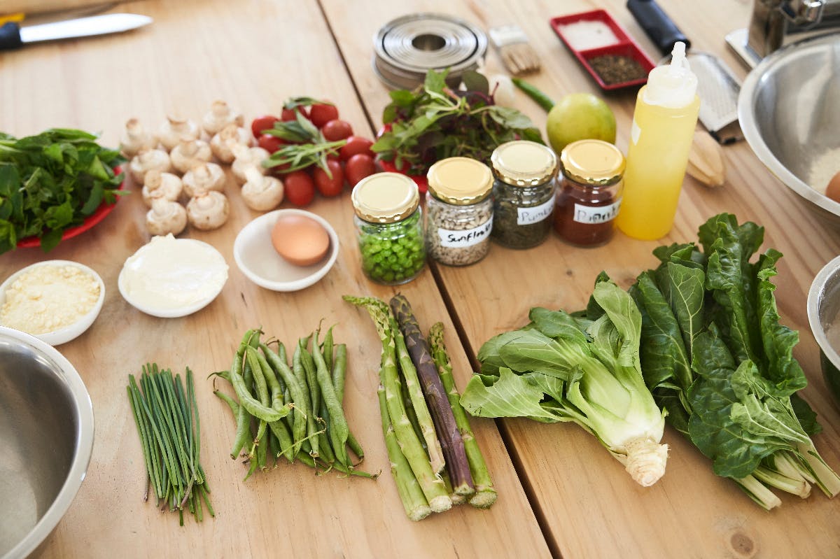 food & spices on a wood table in preparation for cooking