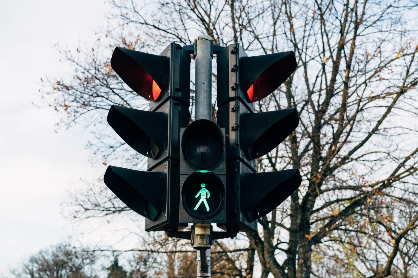 a traffic light with a little green walking man lit