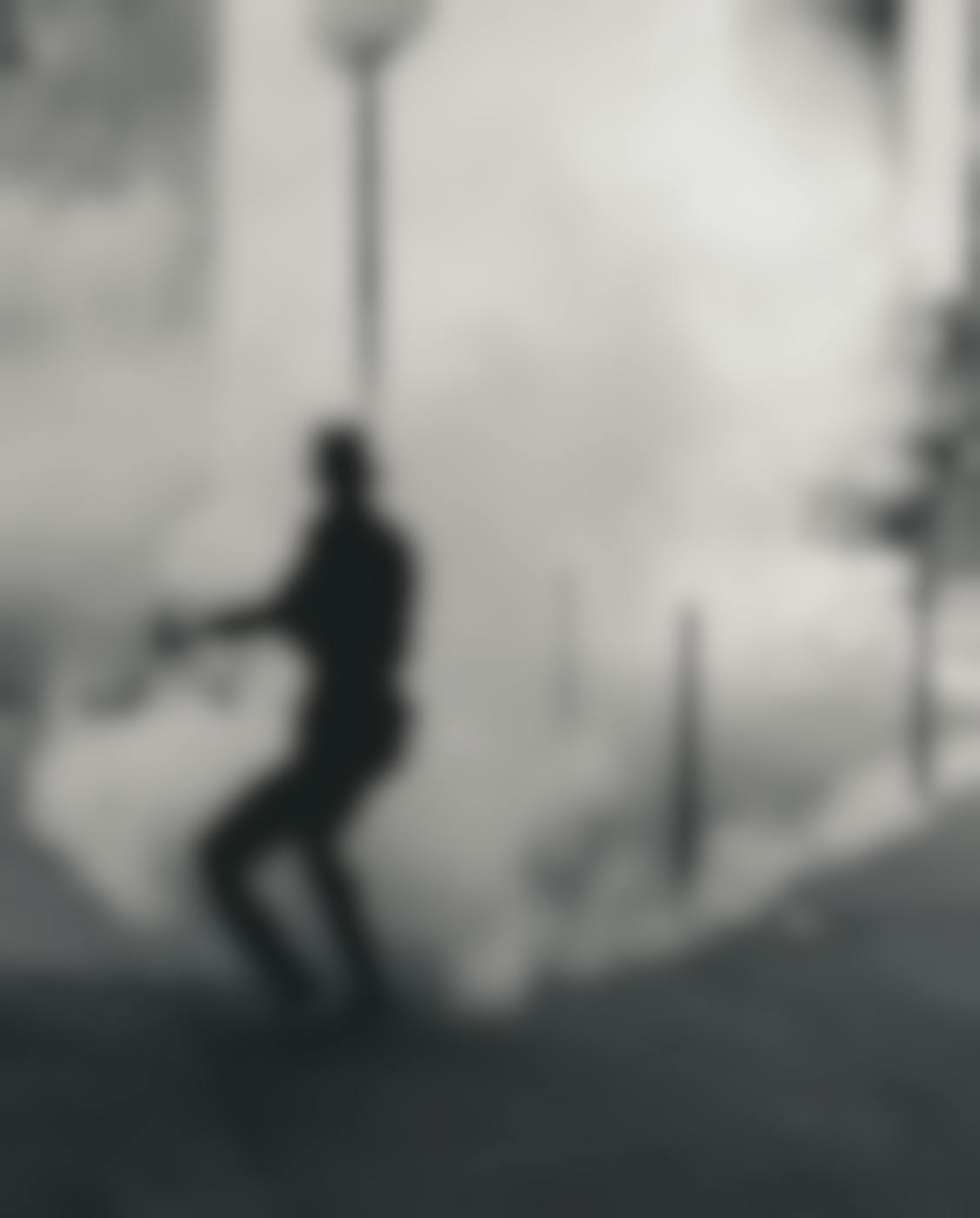 a protester in black covered in a cloud of smoke