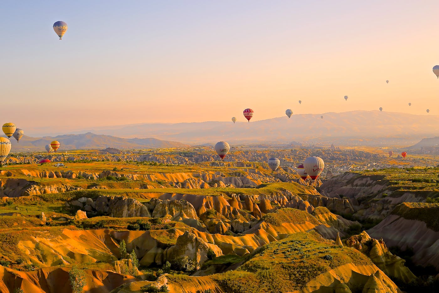 A beautiful landscape with hot air balloons everywhere