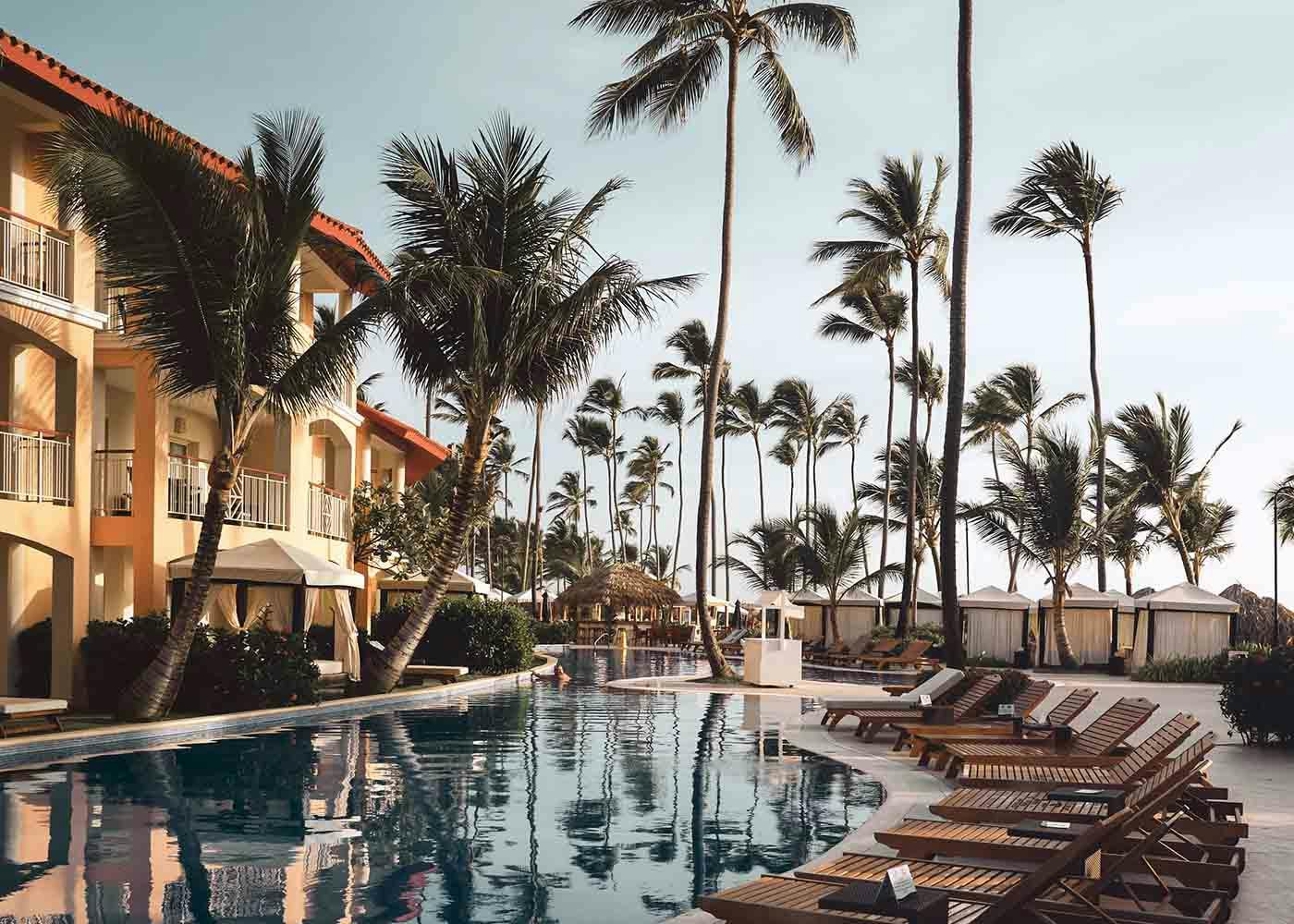 Pool at a luxury condo surrounded by palm trees