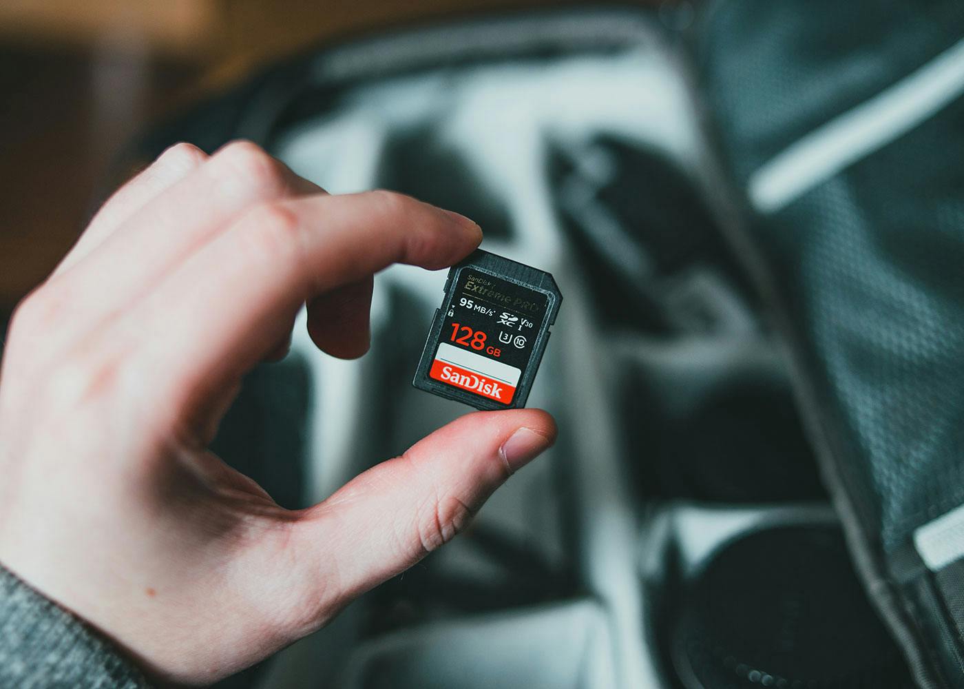 Someone holding a SanDisk memory card