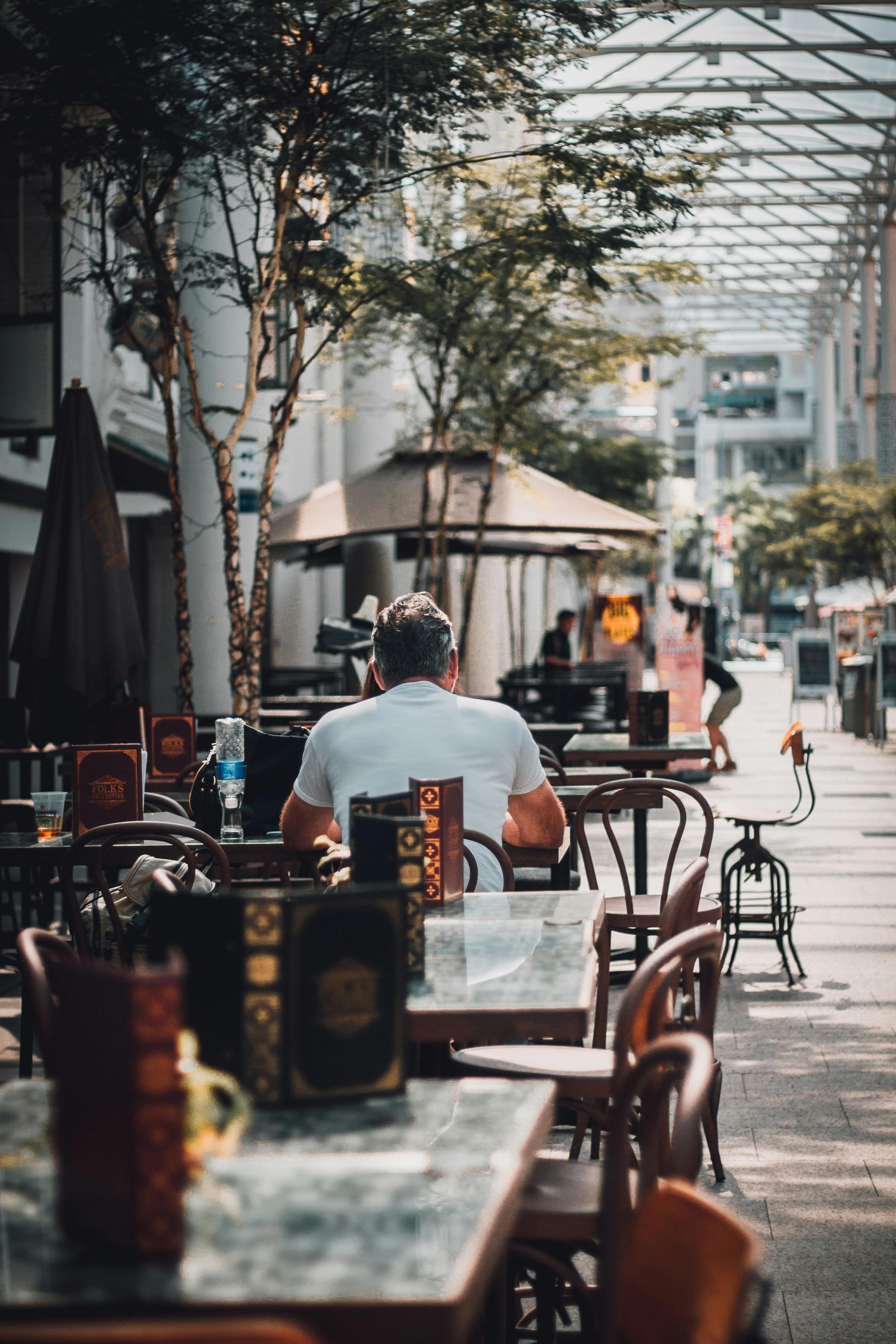 men eating on outdoor cafe patio alone