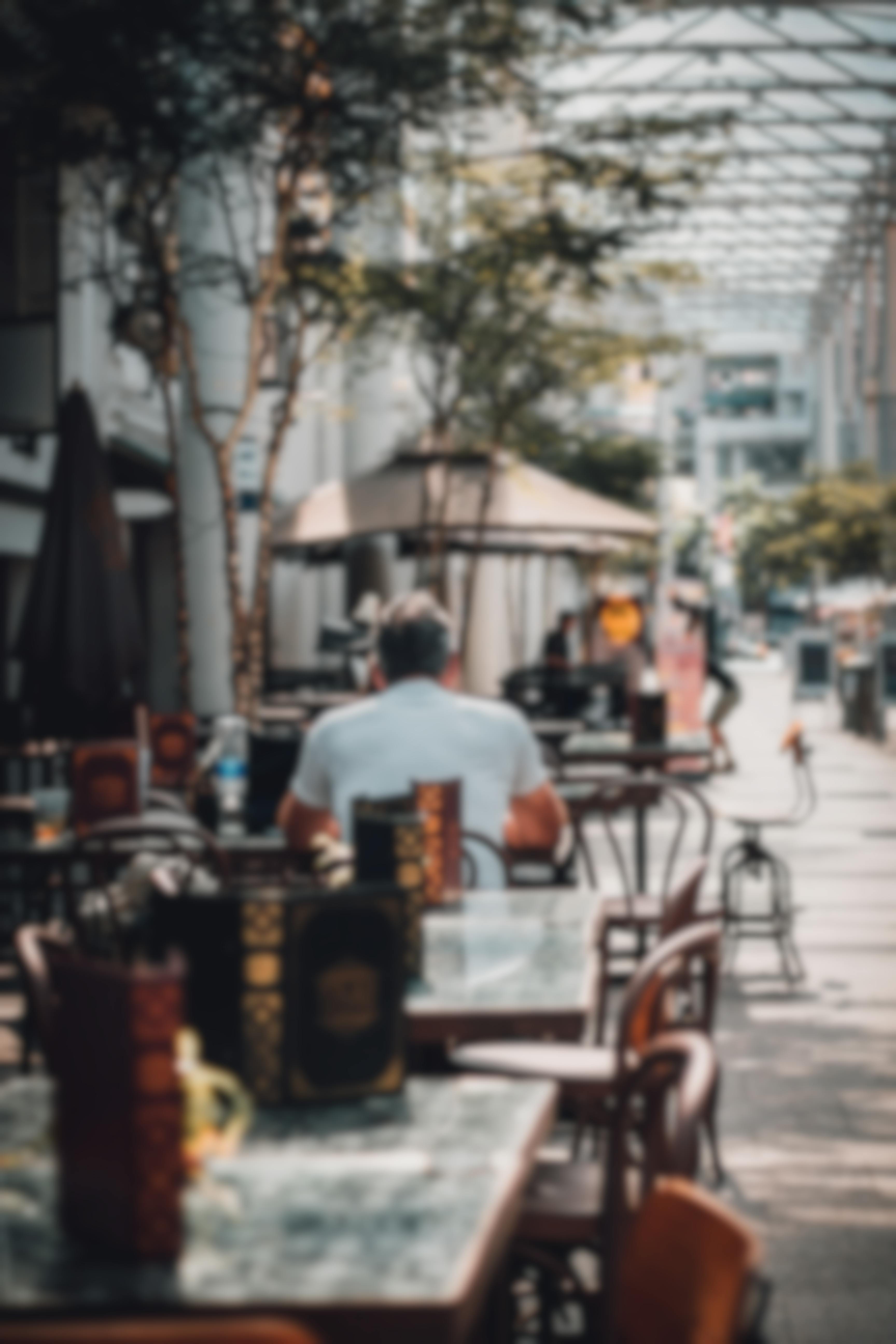 men eating on outdoor cafe patio alone