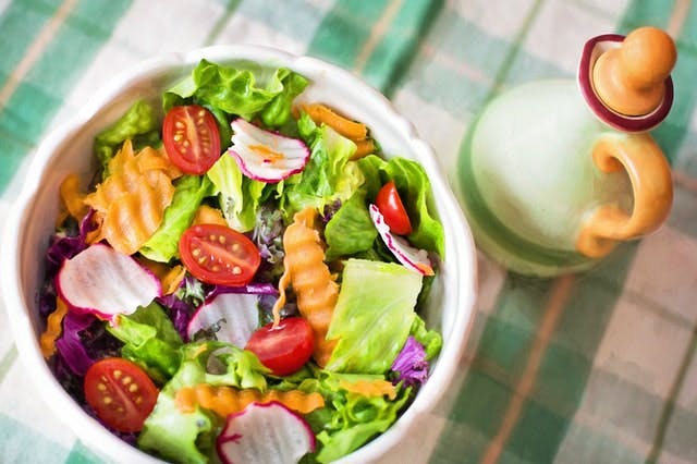 bowl of salad on checkered table cloth