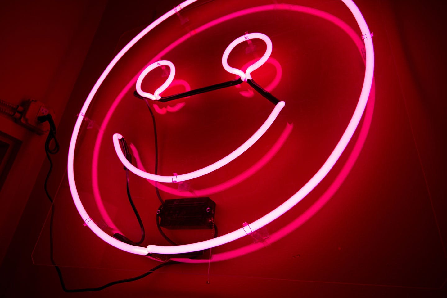 pink neon smiley face sign 