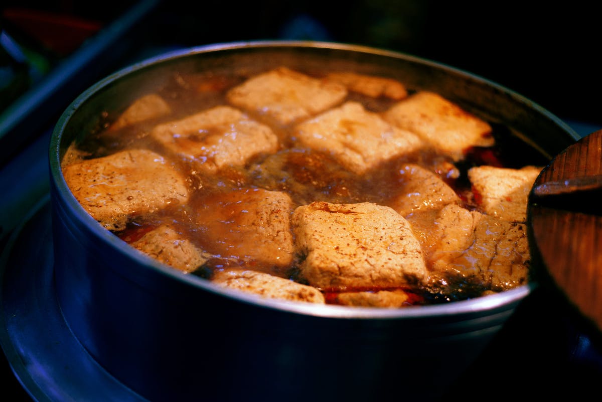 Image of some tofu being simmered in a pot