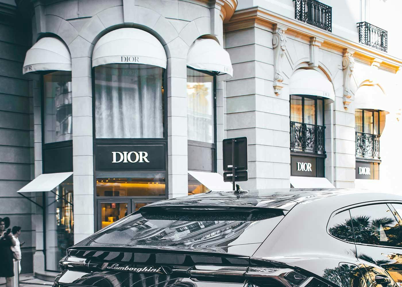 Luxury vehicle driving past Dior