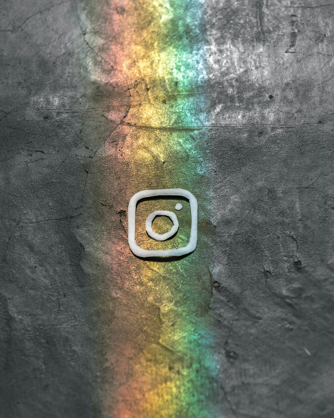 the Instagram logo on a slight rainbow wall