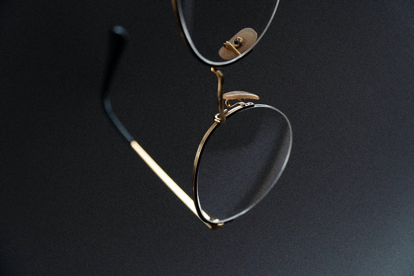 a apir of glasses with round lenses against a black background