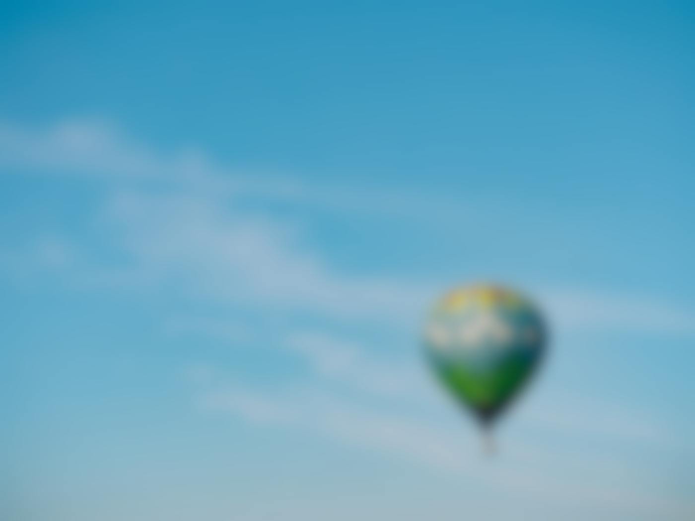 A multicolored hot air baloon floating