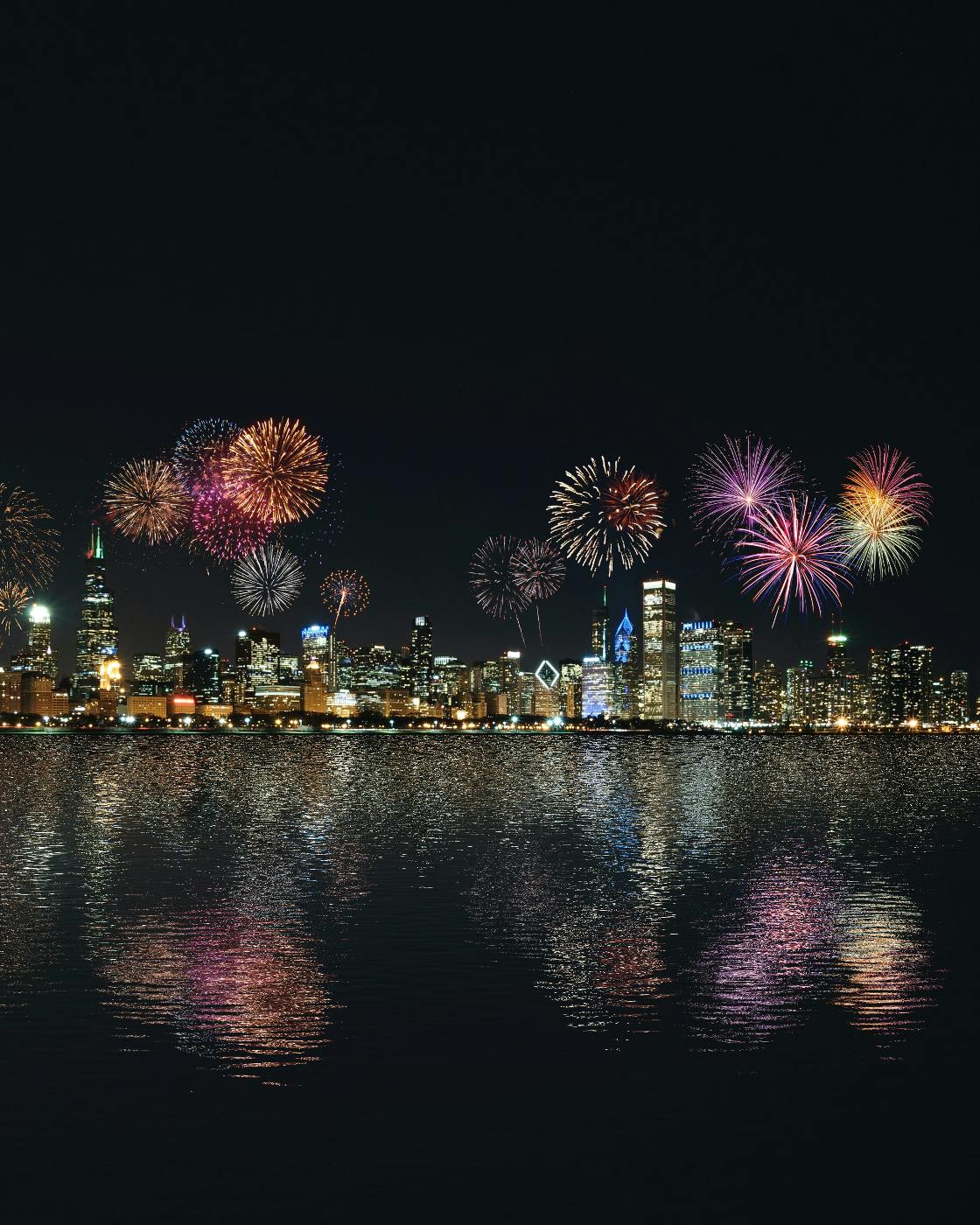 Fireworks over a city and harbor