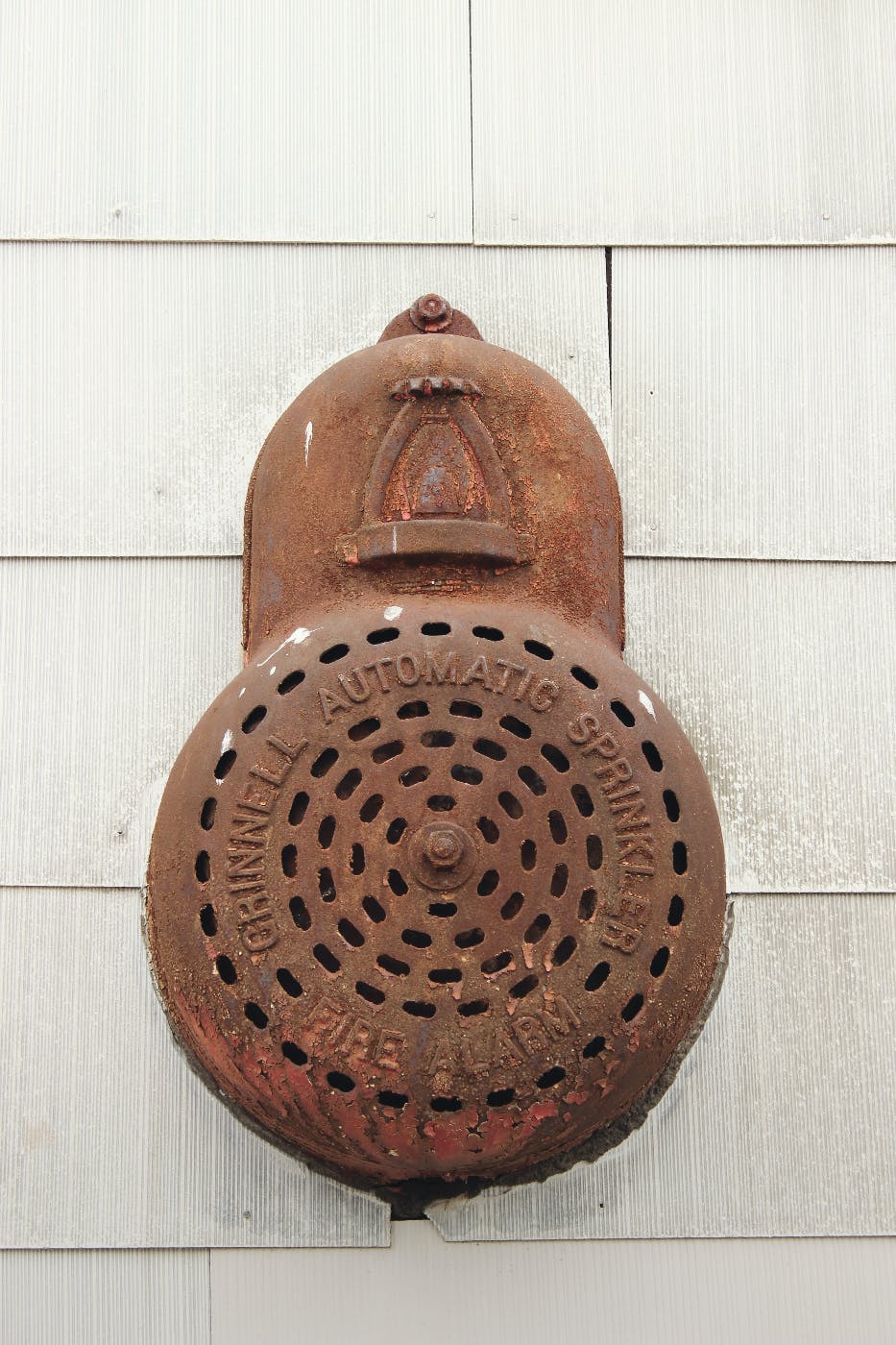 an antique, rusted automatic sprinkler